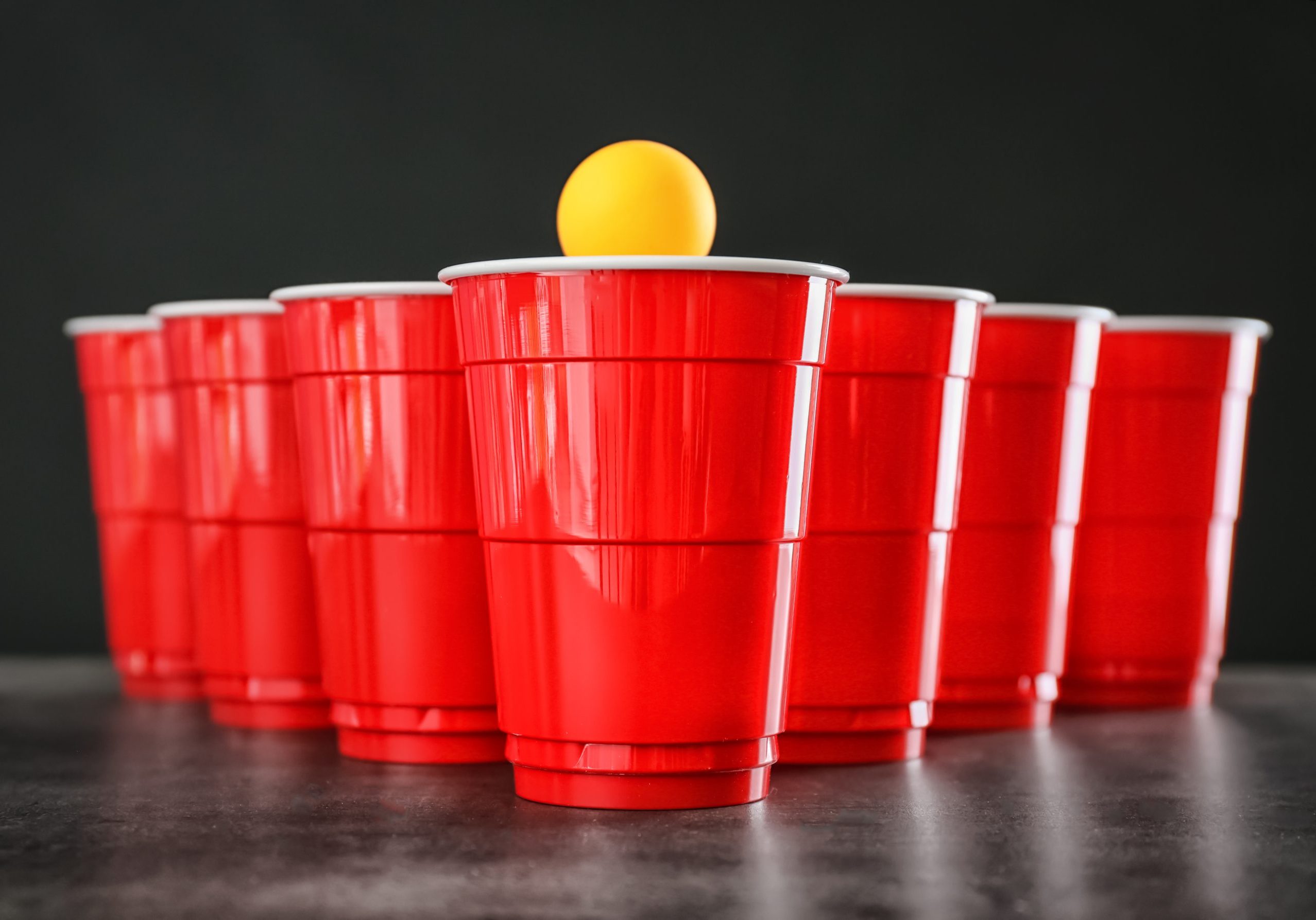 Cups and ball for beer pong on table beer pong